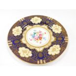 A Crown Staffordshire porcelain cabinet plate, painted with flowers within a cobalt blue and gilt