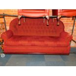 A three seater button back sofa, upholstered in red chenille fabric, 192cm wide.