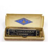 An M Hohner Chromonica chromatic harmonica, boxed.