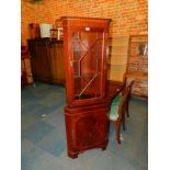A reproduction mahogany corner cabinet, 181cm high, 66cm wide, 37cm deep.