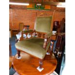 A Victorian oak open armchair, upholstered in green draylon.