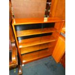 A blonde mahogany glazed bookcase, with four sliding glass doors, 103cm high, 92cm wide, 25cm deep.
