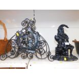 A cast iron Mr Punch door stop, together with a wrought iron four division magazine rack. (2)