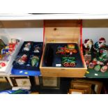 Christmas tree ornaments, some with musical movements, and a Christmas train on stand, cased. (2