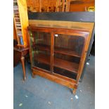 A 20thC stained oak glazed bookcase, enclosing two adjustable shelves, 107cm high, 92cm wide, 25cm