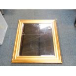 A rectangular giltwood rectangular wall mirror, bevelled glass, 66cm high x 60.5cm wide.