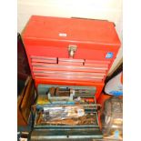 Two red metal tool boxes, containing hand tools, and a further metal tool box containing tools.