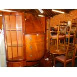 A mid 20thC walnut bureau cabinet, flanked by two glazed doors, with three central drawers, 114cm