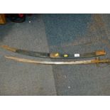 An Indian curved sword, with a brass hilt, and engraved steel blade, with scabbard, blade 74cm