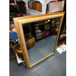 A rectangular gilt wood mirror, inset bevel glass, 117cm high, 91cm wide.