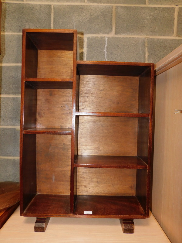 A mid 20thC mahogany pigeon hole unit, of five compartments, raised on stepped feet, 90cm high, 60cm