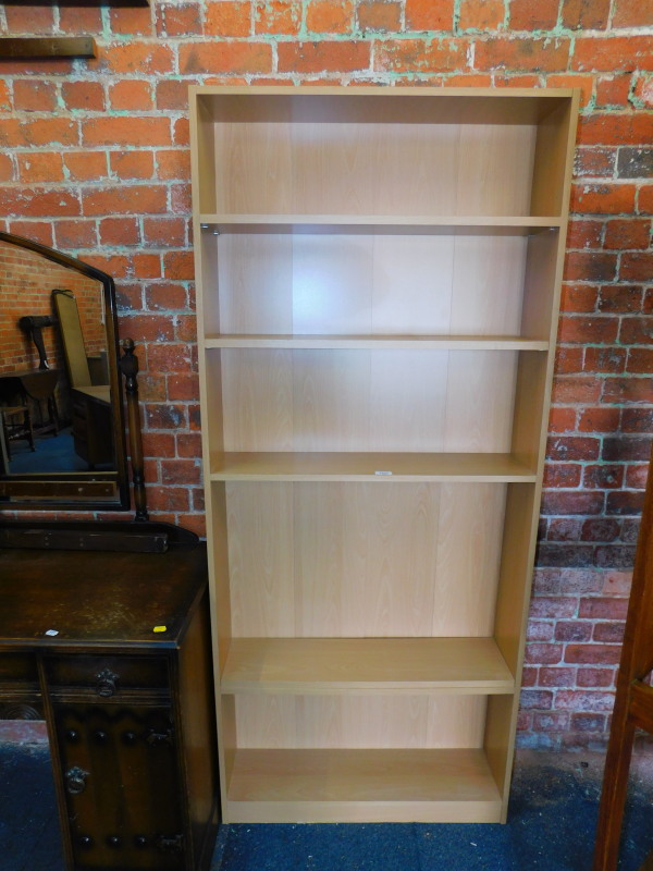 A beech effect bookcase, with five adjustable shelves, 181cm high, 78cm wide, 20cm deep.