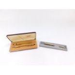 A Parker cartridge pen, and a Cross gold plated ballpoint pen and propelling pencil set, both boxed.