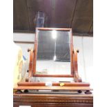 A Victorian mahogany swing framed toilet mirror, raised on rectangular base, on bun feet, 47cm wide,