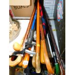 Wooden walking sticks, umbrellas, and a shooting stick. (quantity)