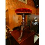 A Victorian rosewood revolving piano stool, with upholstered top raised on a tripod base, 50cm
