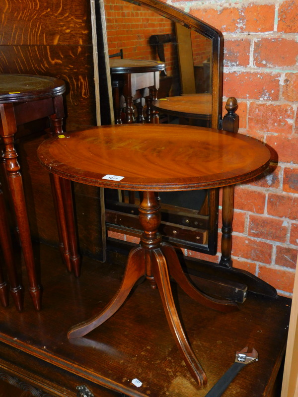 A reproduction mahogany tilt top occasional table, 49cm high, 54cm wide, 40cm deep.