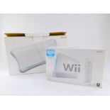 A Nintendo Wii games console, together with a WiiFit board, both boxed, possibly incomplete. (2)