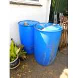 A pair of blue plastic industrial barrels, 94cm high, 59cm diameter. (empty)