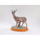 A Capodimonte sculpture as a deer, raised on an oval wooden base, 25cm wide.