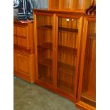 A Legate Furniture teak glazed bookcase, with three adjustable shelves, 128cm high, 84cm wide,