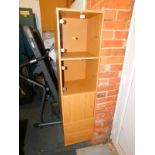 A tall beech effect cabinet, with two glazed sections above a cupboard, with two drawers below,