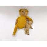 An early 20thC straw filled Teddy Bear, with long snout, 57cm H, and a further Teddy Bear, 28cm H,