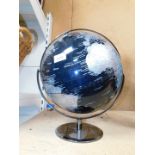 A black and silver terrestrial globe.