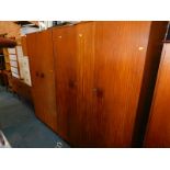 A Durable Suites teak three piece bedroom suite, comprising gentleman's wardrobe, 174cm high,