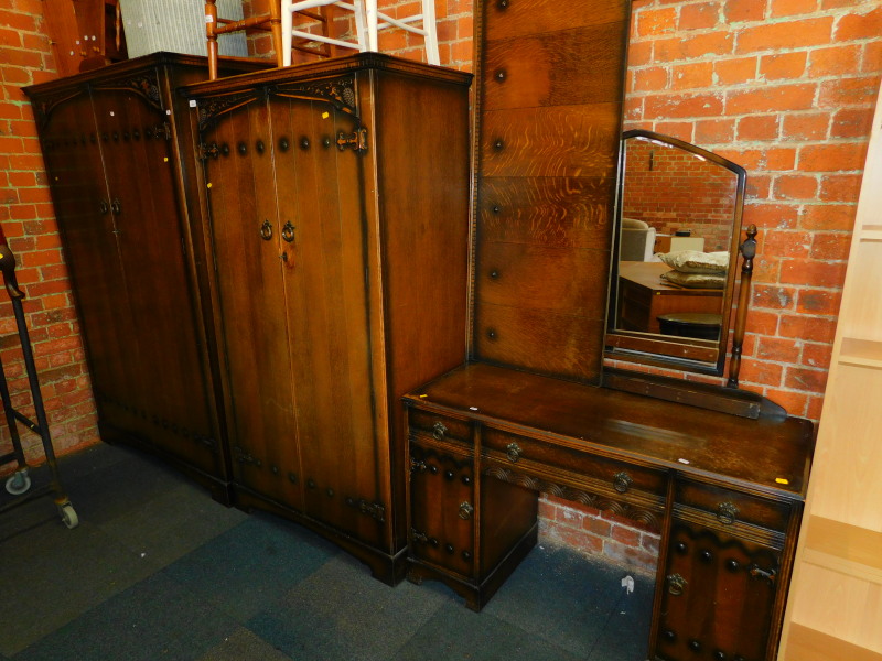 A stained oak Butilux Gothic style four piece bedroom suite, comprising gentleman's wardrobe,