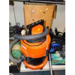 A Vax vacuum cleaner with attachments.