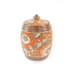 A Doulton Slaters chine tobacco jar and cover, decorated with flowers in orange and white.