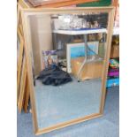 A gilt framed rectangular mirror with inset bevelled glass.