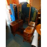 An early 20thC walnut bow fronted dressing table, with full length swing mirror above six drawers,