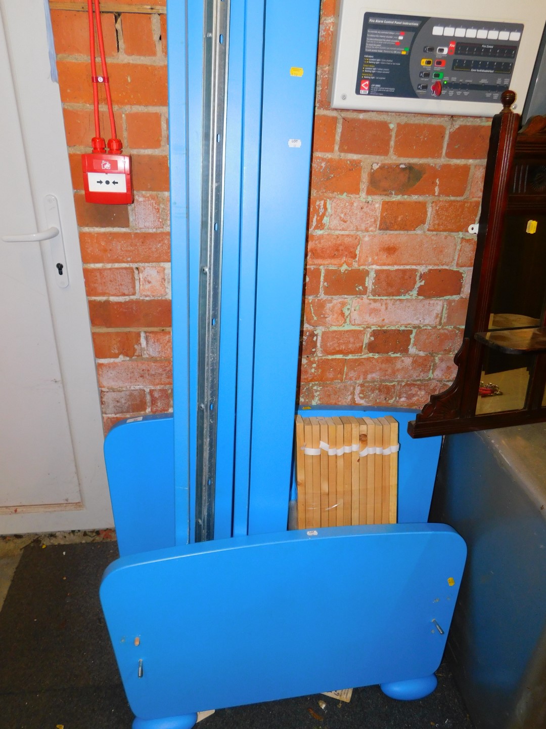 A blue and white painted child's single bed.