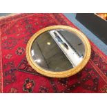 A circular gilt wood wall mirror, inset bevelled glass, 51cm diameter.