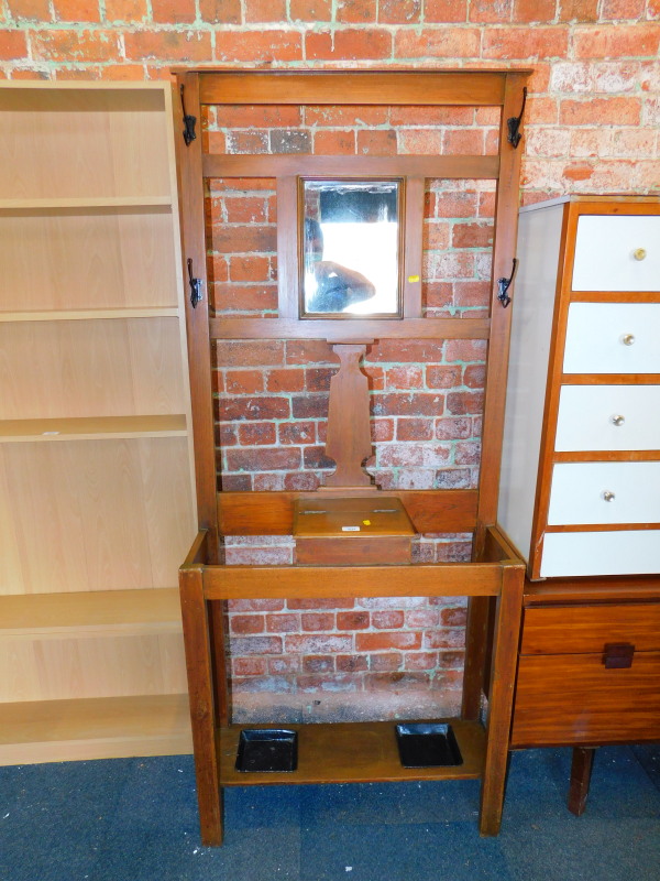 A stained oak hall stand with four hooks, central mirror and glove box, 182cm high, 77cm wide,