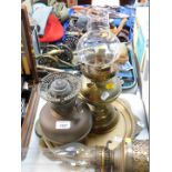A brass wall mounted oil lamp, two further oil lamps and two brass chargers. (5)