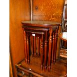 A nest of mahogany tables, with oval and green leather inserts, largest 62cm high, 56cm wide, 35cm