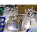 A silver plated oval galleried tray, cut glass claret jug with plated mounts, and two further plated