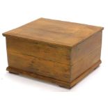 A small reclaimed pine chest, the hinged lid enclosing a vacant interior, on a plinth base, 53cm