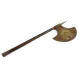 An iron and hardwood axe, decorated to the iron blade with figures within a tent etc., and