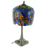 A Tiffany style lamp, the shade decorated with birds, flowers, etc., on a simulated bronze base 52cm
