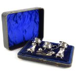 An Edwardian silver five piece cruet, comprising mustard pot, pair of salts with blue glass liners