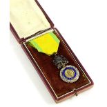 A French Medaille Militarie, in base metal with blue enamel and silvered decoration, gold and