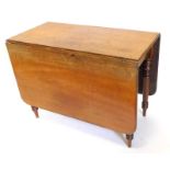 A 19thC mahogany drop leaf table, the rectangular top with rounded corners, on turned tapering legs,