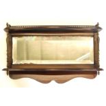 A mahogany and brass wall shelf, with a three quarter gallery, two serpentine fronted tiers, each