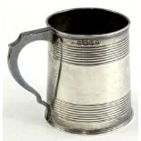 A William IV plain silver cylindrical christening mug, with reeded bands and shaped handle, London