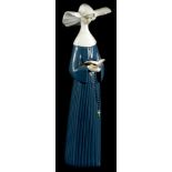 A Lladro porcelain figure of a nun, wearing a blue gown, numbered to underside 5500, 26cm high (