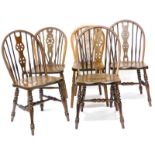 A set of three Windsor kitchen type chairs, each with a pierced wheelback and spindle turned